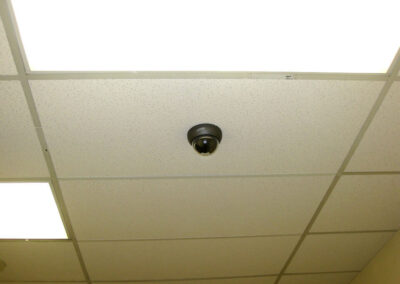 Dome security camera installed in an office ceiling.